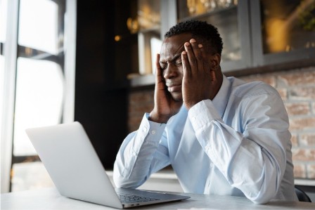 Sad man looking at pc